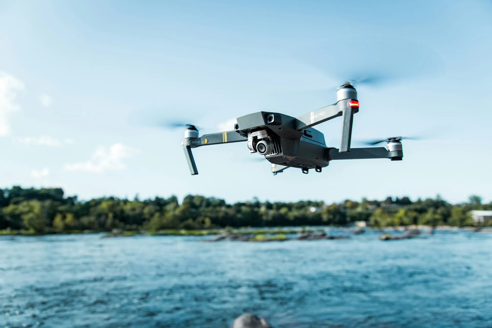 Drone pilot preparing for utility inspection flight at sunrise