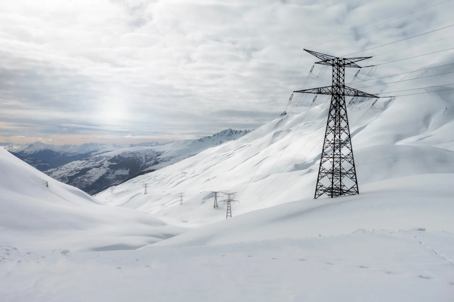 High-voltage transmission towers and power lines against open sky