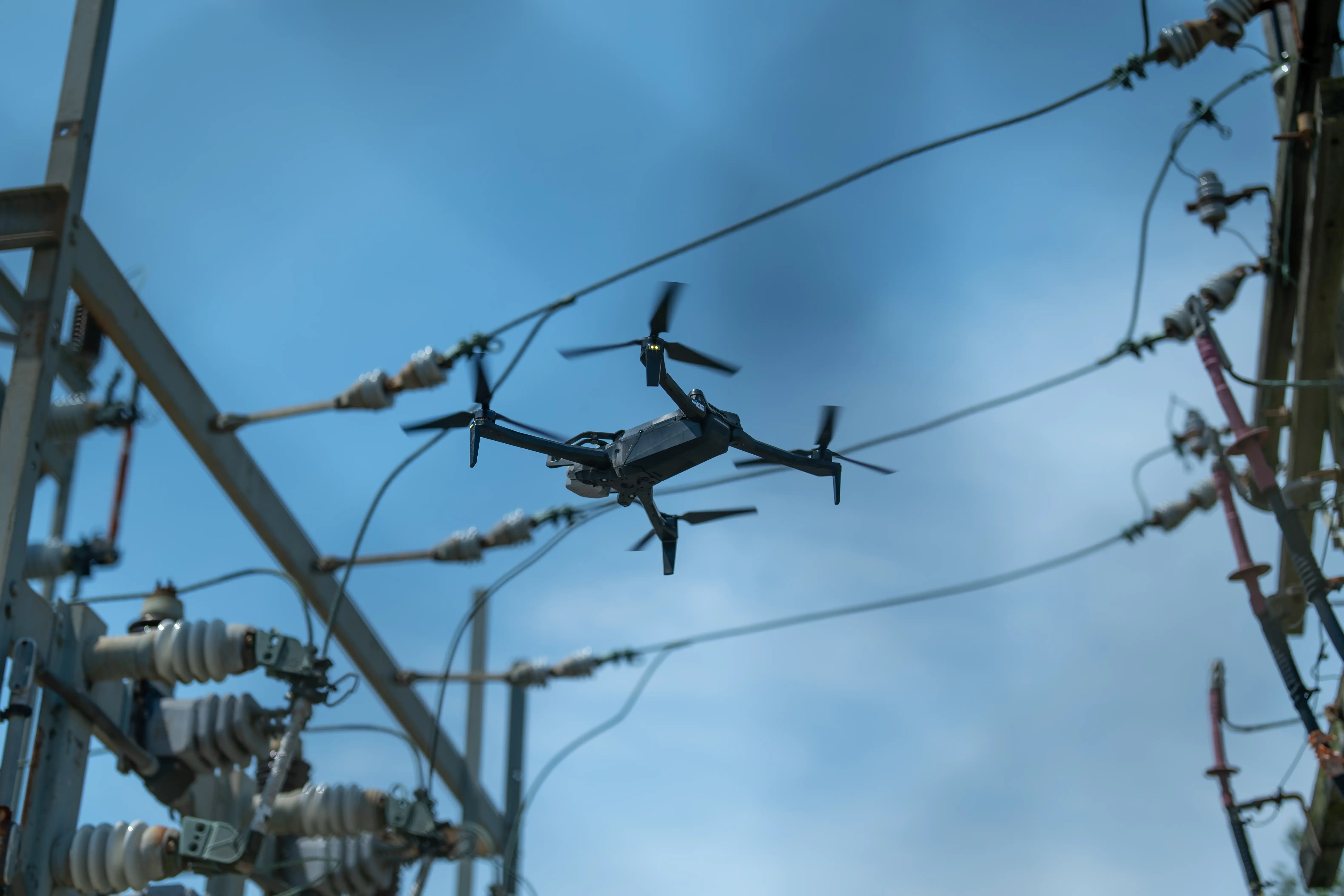 Utility substation being inspected by drone-mounted camera